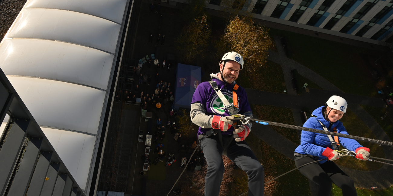 A photo of two people abseiling down the King's Mill Hospital building